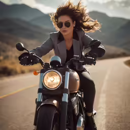 the woman is riding her motorcycle down the road