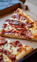 a couple pieces of pizza sitting in a pizza box