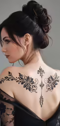 an image of the back of a woman with tattoos