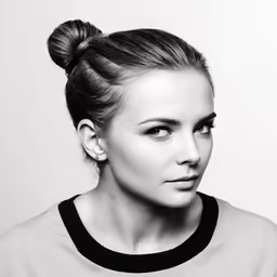 a woman is posing for a photo in black and white