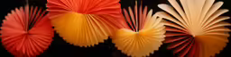 four colorful paper fans are on display for sale