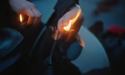 a person lighting candles on a round table
