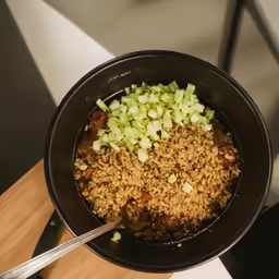 a pot of cooked rice, onions and peppers