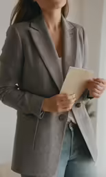 a woman holding her clipboard and looking off in the distance