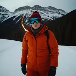 the person is standing with skis near a mountain