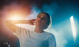 a woman standing next to the sun in her left hand