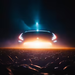 the view of a bright blue car driving through the dark