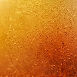 a yellow and brown background with some tiny drops of rain on it