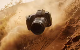 a camera is shown on a dirt road