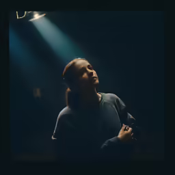 a person that is sitting in the dark