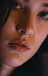 a young girl stares at the camera with her eyes open