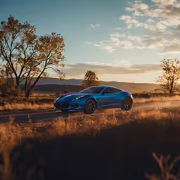 a beautiful blue sports car is driving down a road