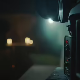 a camera in front of a dark light with bright lights