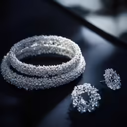 a black table topped with two sets of jewellery