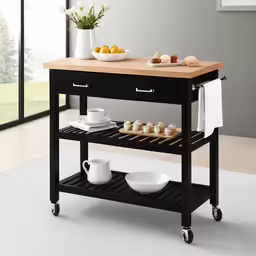 a kitchen cart with two plates and cups