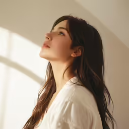 a young woman with a hair blowout standing in the sunlight