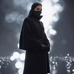 a woman wearing black is standing by the light of sparkle