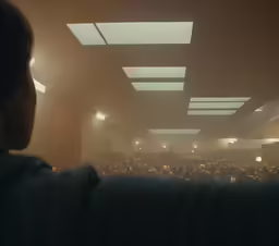 a man who is sitting at a lecture hall