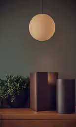 four planters are sitting in front of a round light fixture