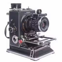 a black camera sitting on top of a metal tray