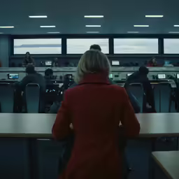a group of people sit around tables in front of them