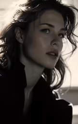 a woman wearing black with a shirt and long hair