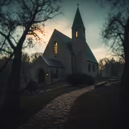 an old church lit by the sun at dusk