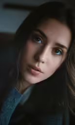 a close up of a person with brown hair and blue eyes