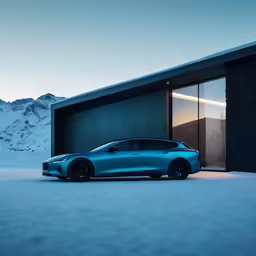 a blue car parked outside a building near mountains