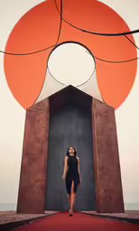 the woman is posing in front of a big thing