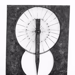 a metal clock with two discs inside of it