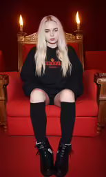a woman is sitting on the arm of a chair