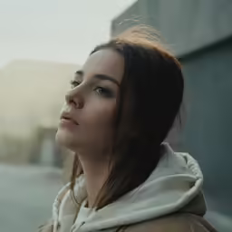 a young girl looking away from the camera with her face slightly obscured