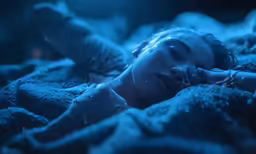 there is a woman that is laying down in a bed