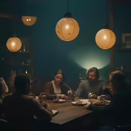 a man and a woman sitting at a table with plates of food