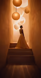 a woman in a ball dress is walking down the stairs