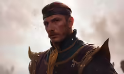 a man dressed as a warrior in a rain storm
