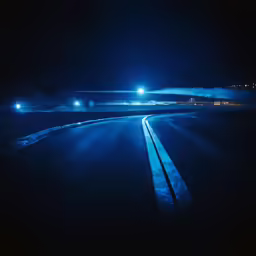 a street at night with one single light on