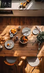 a table with plates and cups and a plate of fruit