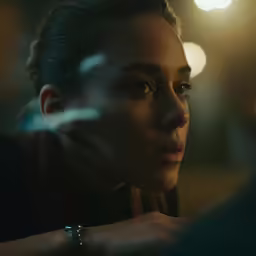 a girl with a wedding band looking at her watch