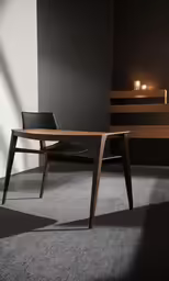 a table and chair next to some candles in a dark room