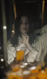 a woman wearing a robe in front of a mirror