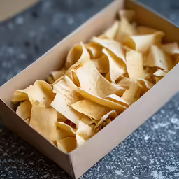 a large box full of cooked and seasoned pasta