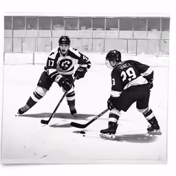 two young men play hockey on an ice rink
