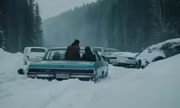 a couple of cars are in the snow