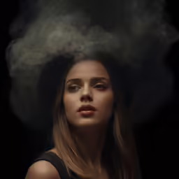 a young woman with smoke on her face