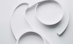 two circles with curves and rounded edges in white paper