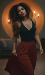 a woman wearing a black top and red high waist pants