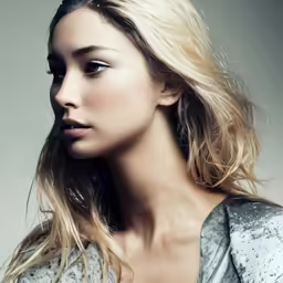 a beautiful blond woman in grey shirt with frizzy hair