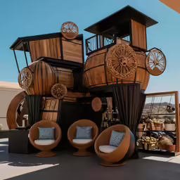 a wooden sculpture made from wood with white chairs and clocks